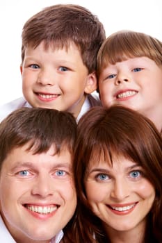 Photo of smiling father, mother and two siblings looking at camera