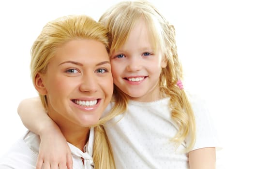 Portrait of little girl embracing woman in white clothes