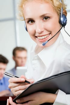 Portrait of young beautiful friendly business woman holding the pen and folder