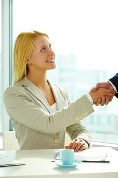Image of businesswoman handshaking with business partner