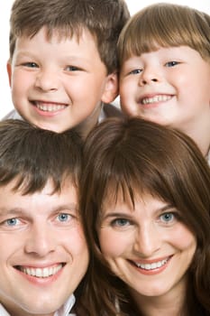 Photo of attractive father and mother with two siblings above them looking at camera