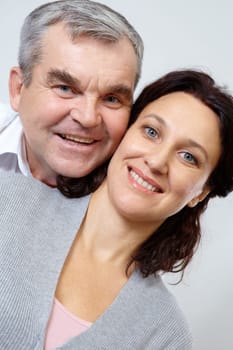 Portrait of happy mature couple looking at camera with smiles