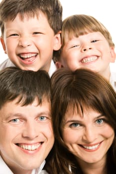 Photo of smiling father, mother and two siblings looking at camera
