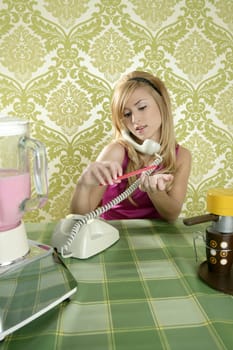 Housewife retro vintage talking phone in kitchen with nail file