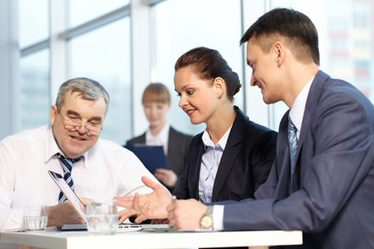 Four businesspeople working together in office