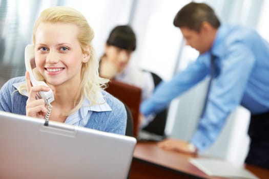 A young businesswoman with a telephone receiver