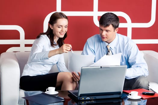 Business woman pointing at document and speaking with her boss