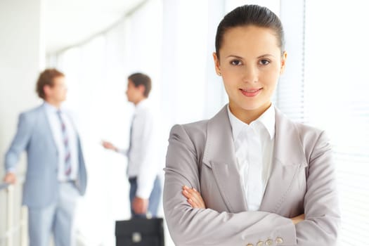 Portrait of an attractive woman against her male colleagues