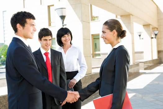 Photo of successful people handshaking after striking deal outdoors at meeting