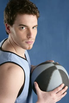 Basket player young man over blue grunge background