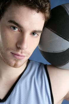 Basket player young man over blue grunge background