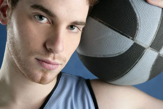 basketball young man basket player portrait over blue studio background
