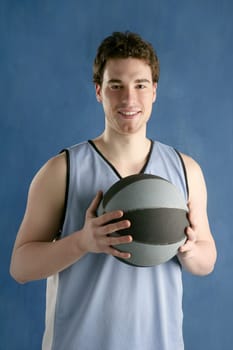 basketball young man basket player portrait over blue studio background