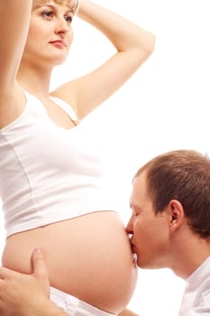 Image of happy man kissing pregnant belly of his wife