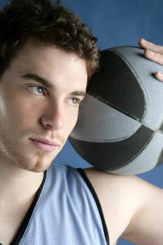 basketball young man basket player portrait over blue studio background