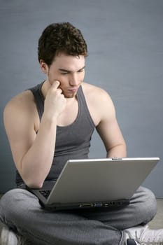 student gesture with laptop over gray background