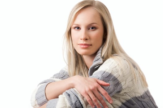 Portrait of blond female in woolen looking at camera