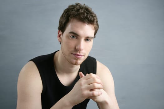 young man portrait posing looking camera over gray background
