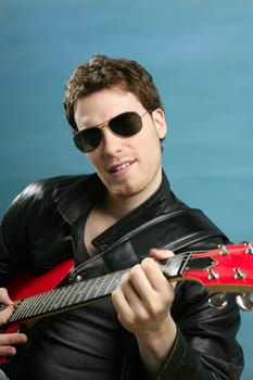 sexy rock man sunglasses and leather black jacket over blue