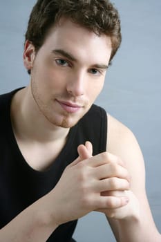young man portrait posing looking camera over gray background