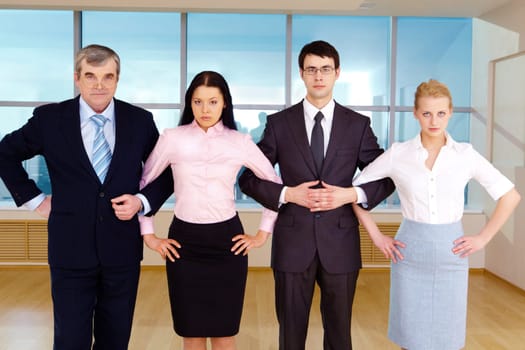 Portrait of smart business group standing in row and crossing their arms