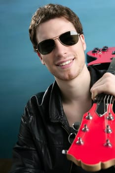 sexy rock man sunglasses and leather black jacket over blue