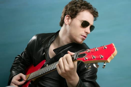guitar rock star man sunglasses and leather perfect jacket over blue