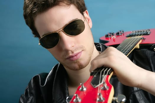 sexy rock man sunglasses and leather black jacket over blue