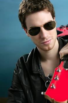 guitar rock star man sunglasses and leather perfect jacket over blue