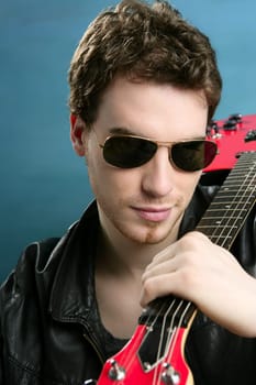 sexy rock man sunglasses and leather black jacket over blue