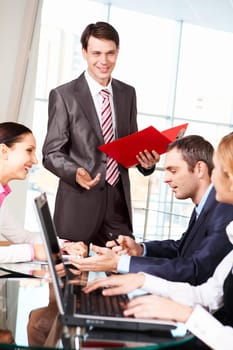 Image of business group discussing new project or plan in the office