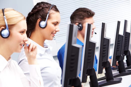 Group of customer representatives working in the computer class
