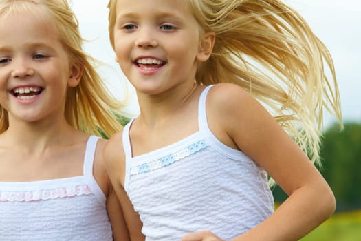 Portrait of cute girls running and smiling