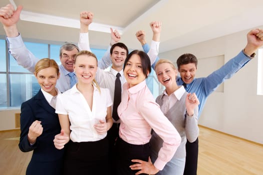 Portrait of successful people raising hands showing gladness