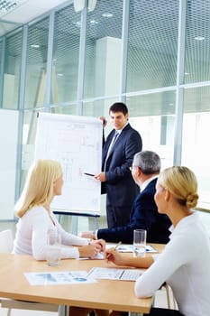 Businessman showing a plan to his colleagues
