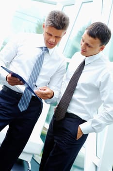 Two smart businessmen discussing new strategy at meeting