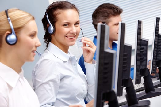 Business team of operators sitting at the table during telephone conversation