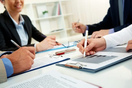 Businesspeople examining documents at their workplace