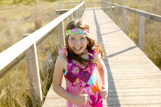 One teen girl running outdoor at the park, hippy pink dress