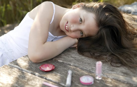 beautiful young girl portrait with make up set outdoors, at the park