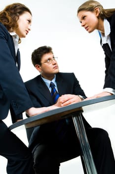 Image of business man looking at one of agressive women