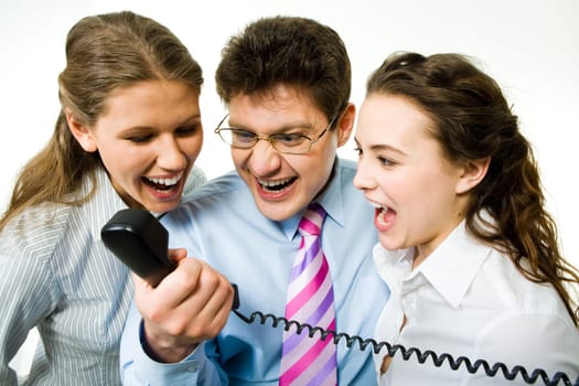 Portrait of three business people screaming on the telephone