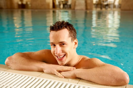 Portrait of happy swimmer in swimming pool