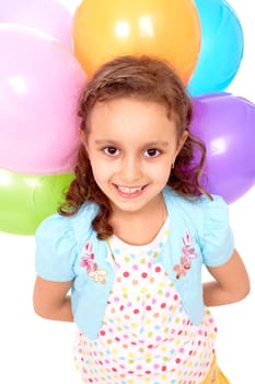 Portrait of happy girl with colorful balloons behind her back