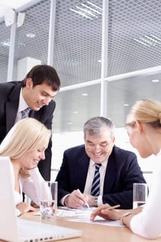 Business team of four people sitting and working together