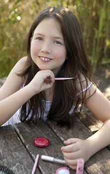 beautiful young girl portrait with make up set outdoors, at the park