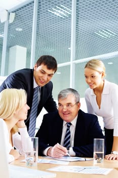 Business team of four people interacting in office at meeting