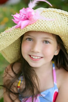 Closeup portrait of beautiful teen little girl with hat in the park