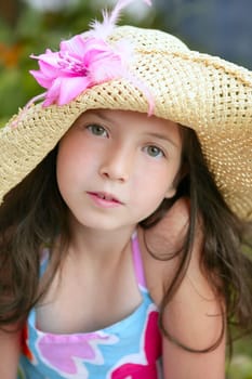 Closeup portrait of beautiful teen little girl with hat in the park