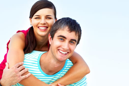 Portrait of a young couple, the girl is on her boys back